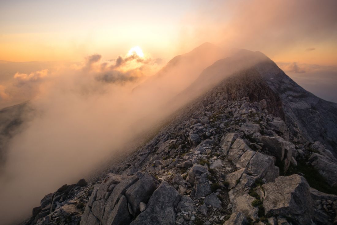 A strip of fog slides over Bayuvi Dupki