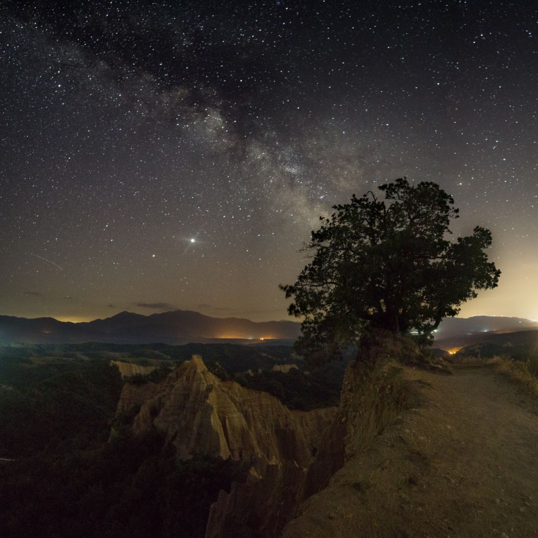 Pyramids at night under the Milky Way.