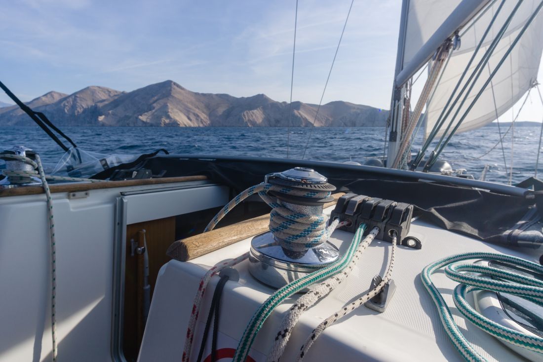 Vines and ropes of the mainsail, with Prvić Island in the background.